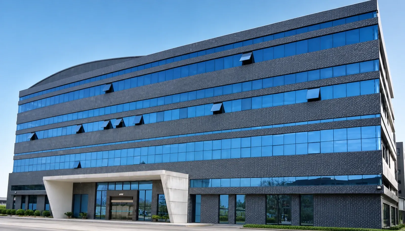 Front elevation of the factory, with blue glazing and its main entrance